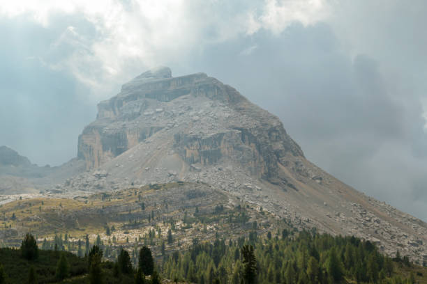 istock Armentarola - A close up view on a sharp and stony mountain in Italian Dolomites. The massive mountain is surrounded by clouds 1292460853