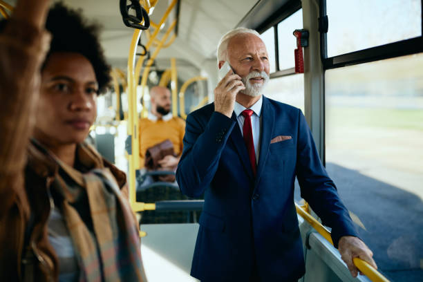 istock Happy mature businessman talking on the phone while commuting by bus. 1292461038