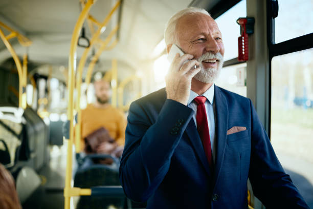 istock Happy senior businessman making a phone call while commuting to work by bus. 1292465522