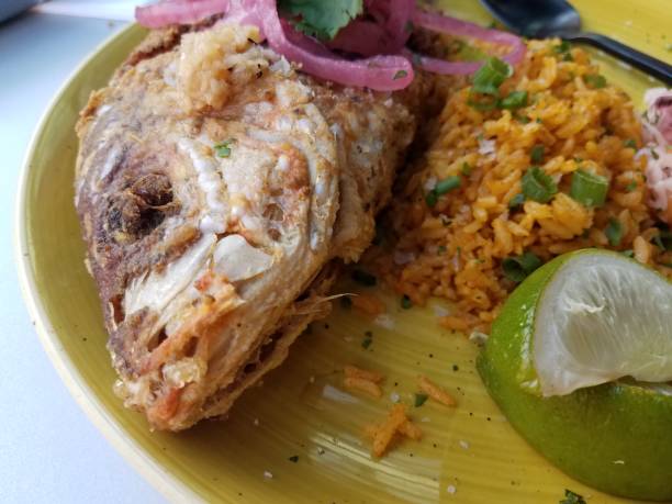 istock fried fish from Puerto Rico on plate with rice 1292468675