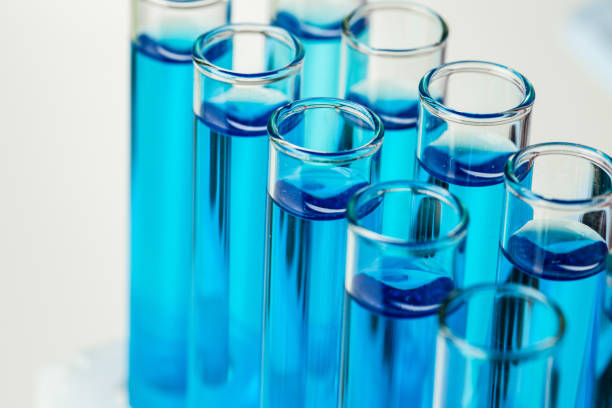 istock Laboratory test tubes with blue liquid close up 1292468694
