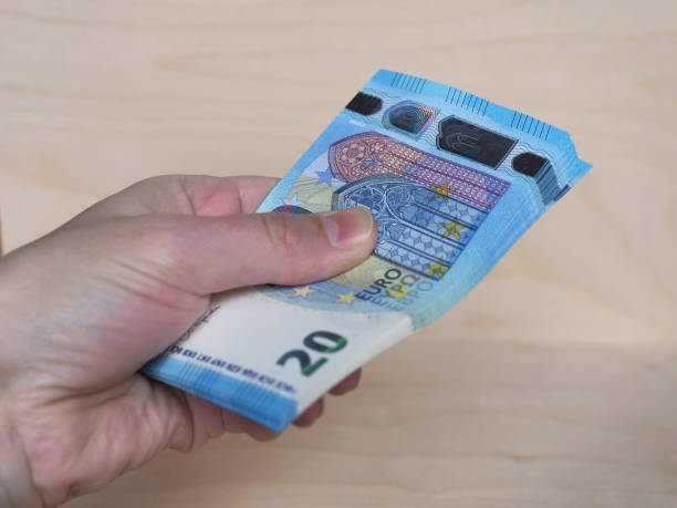 istock Hand holding Euro notes, European Union 1292469704