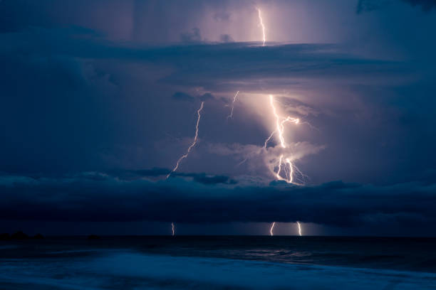 istock Lightning Rays Strikes and Thunder Over the Ocean in Dark Sky 1292469937