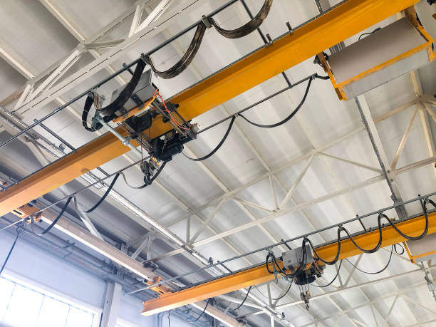 istock Overhead cranes inside industrial building. Bridge cranes inside hangar 1292472170