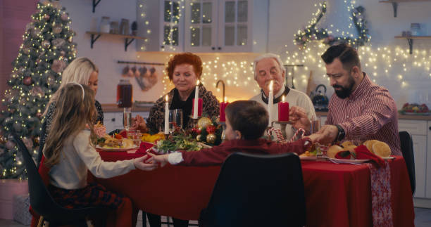 istock Religious family praying before Christmas dinner 1292472405