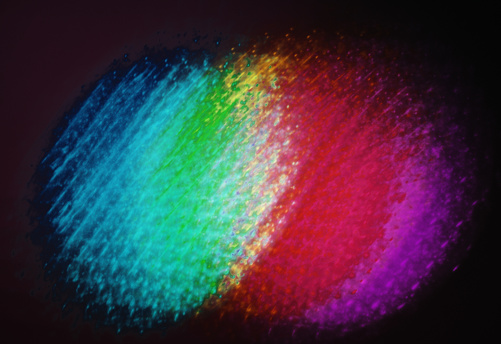 Background: defocused abstract light shapes, of various colours, created illuminating the digital sensor with partialy focused light and digitally enhanced