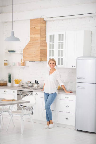 istock Blonde housewife in the kitchen feeling good 1292475330