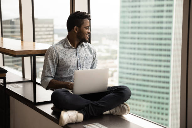 istock Smiling biracial man relax at home using laptop 1292475530