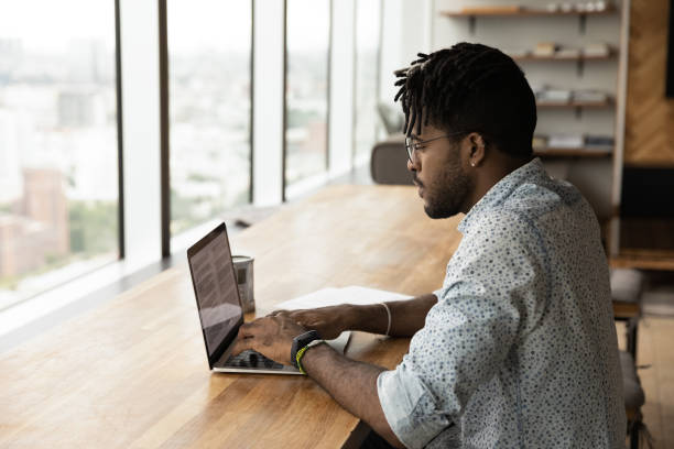 istock Millennial biracial man work online on computer at home 1292475536