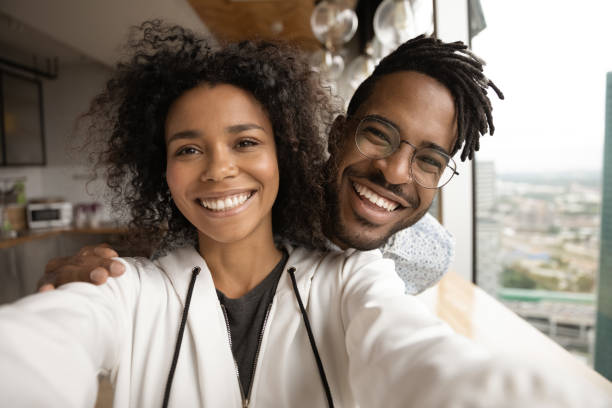 istock Smiling biracial couple make selfie at home together 1292475576
