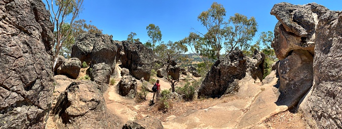 Newham, Victoria, Australia - January 7, 2019: Lone female tourist is exploring the Hanging Rock Reserve in Victoria, Australia.