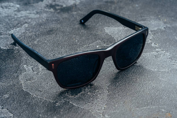 istock Dark male sunglasses on grey concrete surface 1292475712