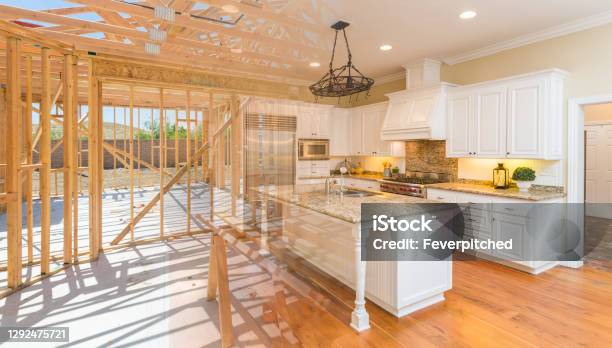 House Construction Framing Gradating Into Finished Kitchen Build Stock Photo - Download Image Now