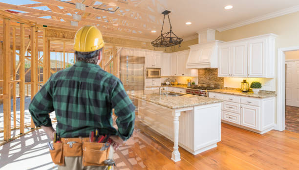 contractor standing in front custom kitchen construction framing gradating into finished build - construction worker imagens e fotografias de stock