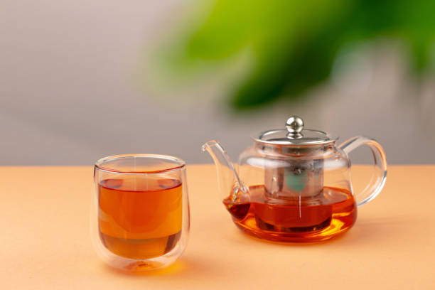 istock Glass teapot and cup with black tea 1292477406