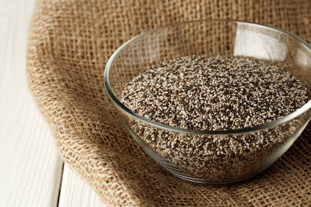istock Glass bowl with chia seeds on wooden table 1292478039