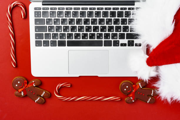 istock Christmas decorations and computer laptop on paper background 1292478413
