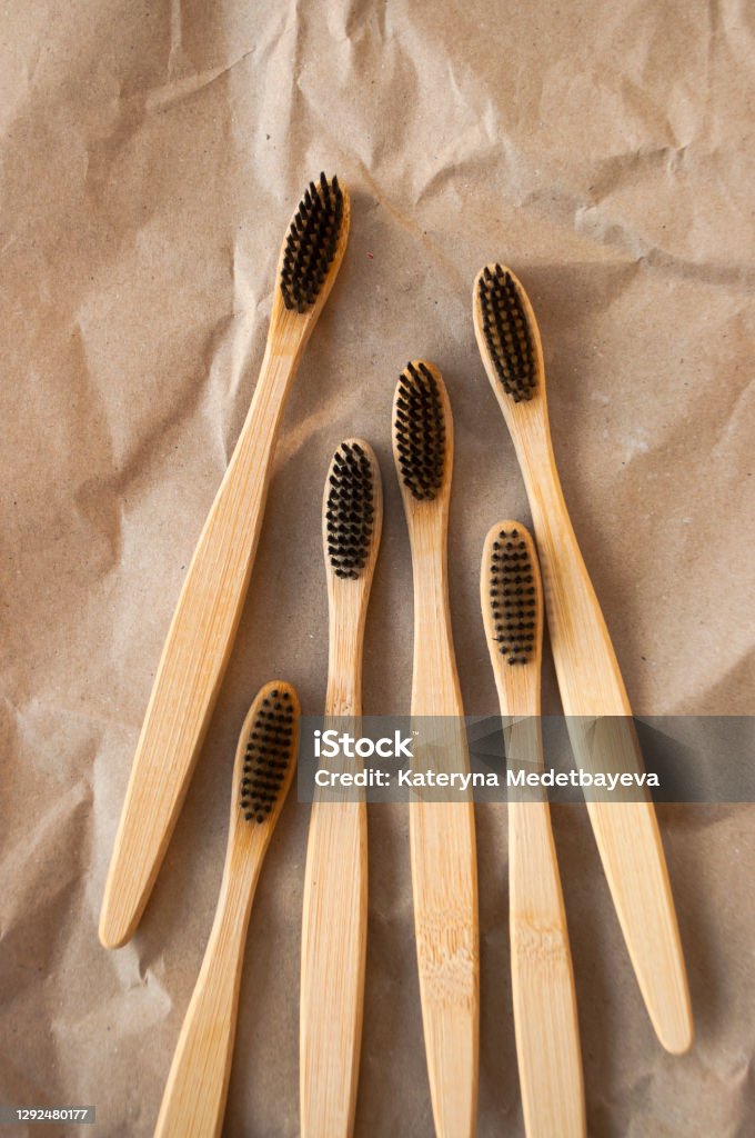 Bamboo toothbrush on beige background. Many0 bamboo toothbrushes on beige paper background. Zero watse concept. Bamboo - Material Stock Photo