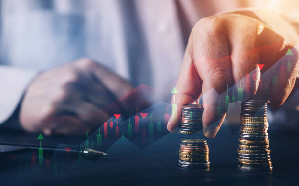 istock Businessman holding coin stack with digital increase graph. Business growing financial concept. 1292483733
