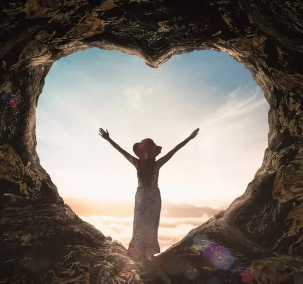 Photo of Alone woman standing on cave of heart