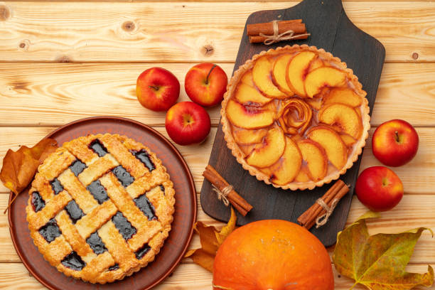 istock Thanksgiving berry and apple various pies on wooden surface, top view 1292486433