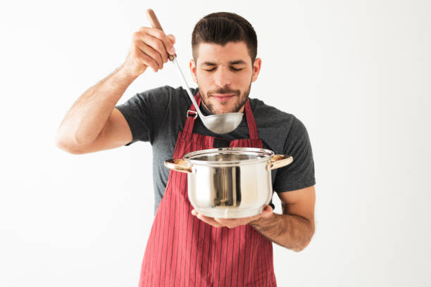 istock Handsome guy is smelling the food he finished cooking 1292488353