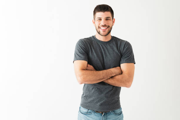 istock Young handsome guy with folded arms and a big smile 1292488546