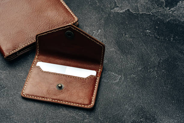 istock New brown leather wallet on dark background 1292490412