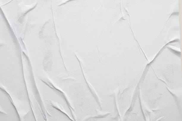 istock Blank white crumpled and creased paper poster texture background 1292492461