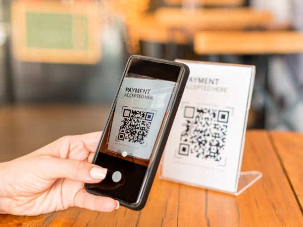 istock Young man capturing qr code through the digital camera of the cell phone for bill payment. 1292493465