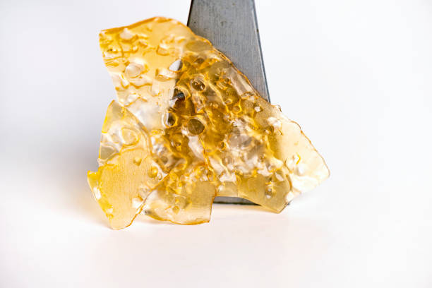 Cannabis oil concentrate aka shatter isolated over white stock photo