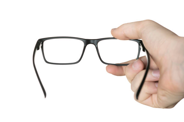 istock isolated on white person's hand holding a eyeglasses, mockup design, optical frame 1292495860