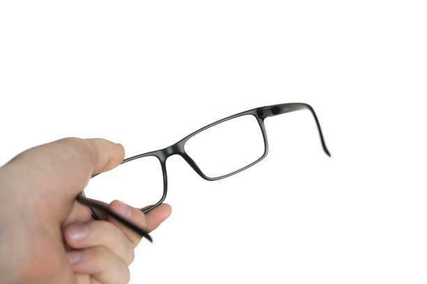 istock isolated on white person's hand holding a eyeglasses, mockup design, optical frame 1292495863