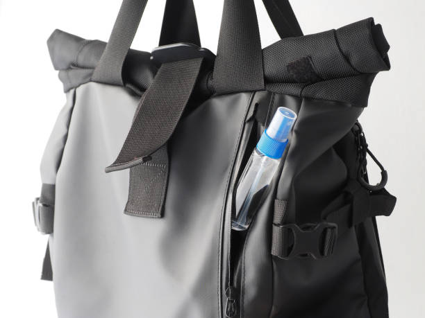 istock Bottle of disinfecting alcohol spray in modern black backpack. 1292497352