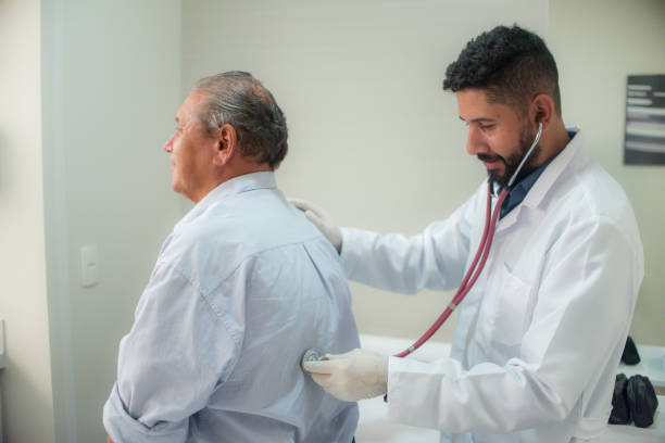 istock Doctor examining lungs of elderly man 1292498180