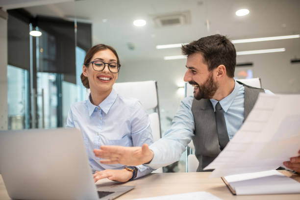 istock Two young workers teamed up to finish paperwork on time. 1292499675