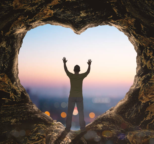 istock Alone man standing on cave of heart 1292500740
