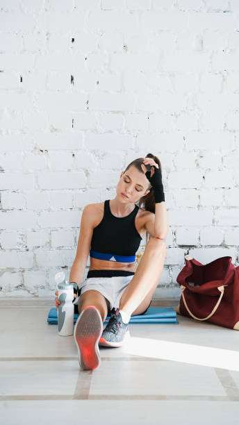 istock A girl is resting after an individual training session with a professional boxer in a bright training room 1292501556
