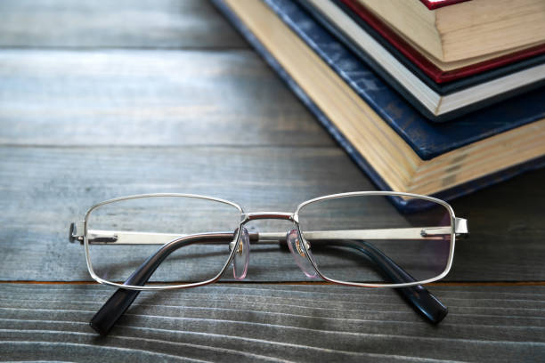 istock Glasses and stack of hardcover books 1292502465