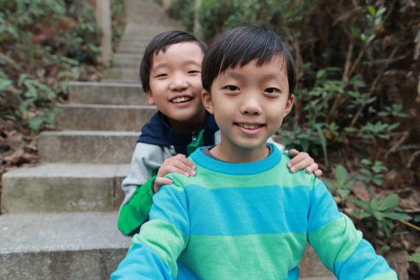 istock Happy Chinese boy playing in a park 1292503373