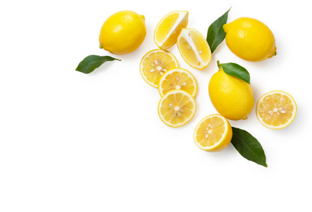 istock Lemons placed on a white background with copy space and cut in half. View from directly above 1292503426