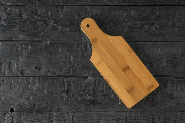 istock A small cutting Board on a black wooden table. 1292505744
