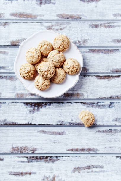 istock Amaretti (Italian biscuits) on bright wooden background. Top view. Copy space. 1292506608