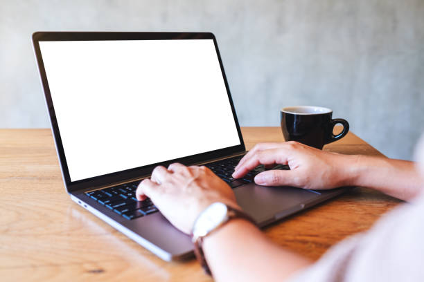 istock a woman using and typing on laptop computer keyboard with blank white desktop screen 1292515908