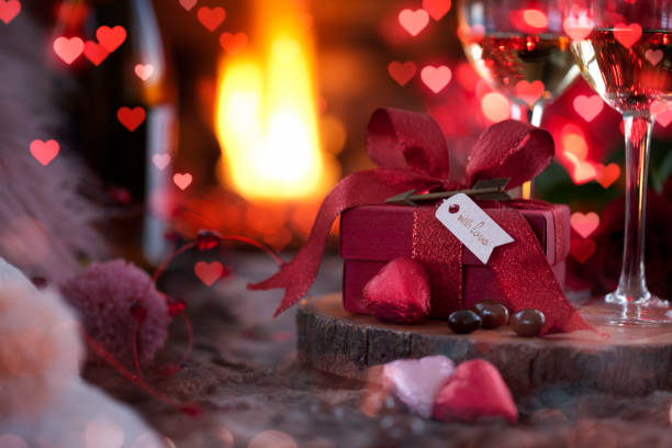 istock Valentine's Day Gift and White Wine in front of the Fireplace 1292517564