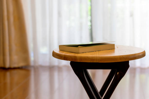 istock Wooden desk with a book 1292519959