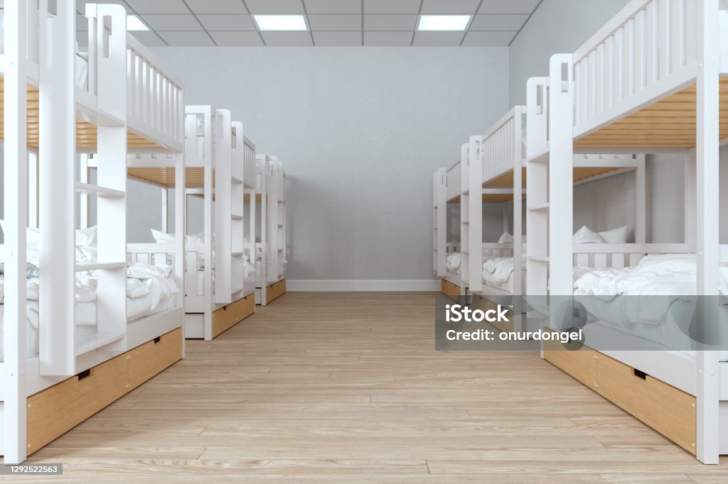 Modern College Dorm Room With Messy Bunk Beds And Parquet Floor. Hostel Stock Photo