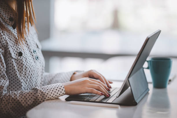 istock Cropped shot of businesswoman working,typing on tablet computer. Selective focus,Soft focus. 1292527357