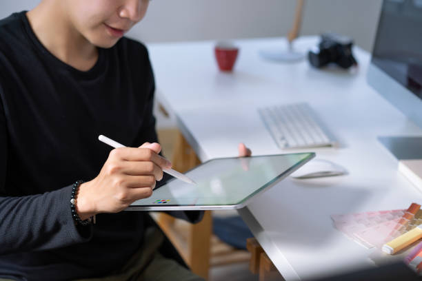 istock Young asian businessman working at home with tablet on desk. 1292527360