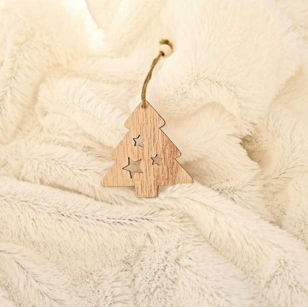 istock decorative christmas toy tree  on delicate  fur soft  light beige plaid, abstract fabric background with waves. Beige soft textile texture . New year and christmas concept, template for card 1292527607